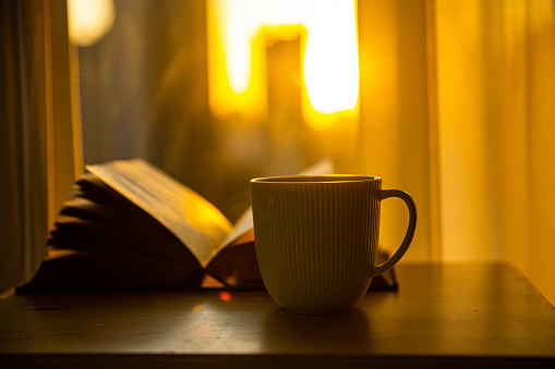 A cup of coffee and a book on the table