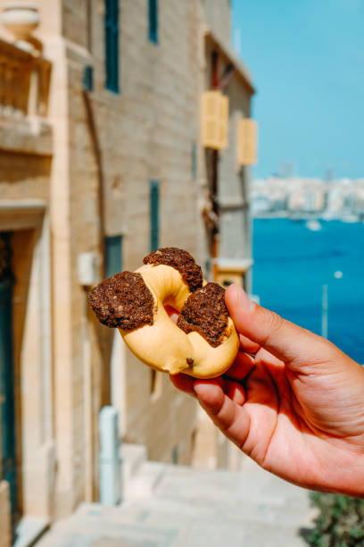 istock man holds a qaghaq tal-ghasel in Malta 1432524330