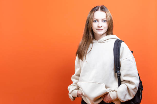 istock American student woman wearing backpack holding notebook over isolated yellow background with a happy face standing and smiling with a confident smile 1432524934