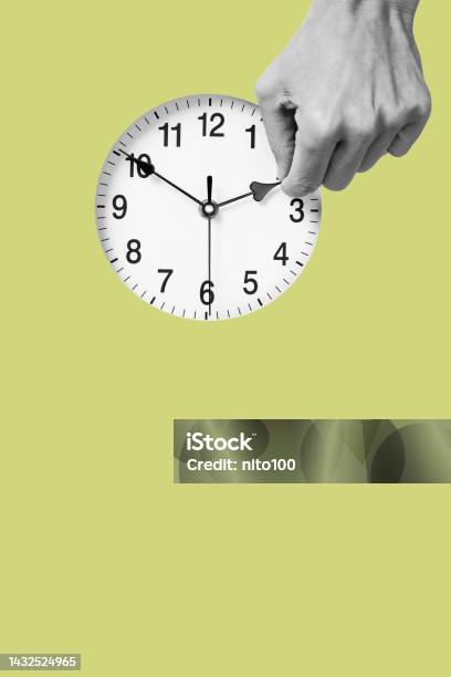 Man Resets A Clock Backward Or Forward Stock Photo - Download Image Now - Time Clock, Clock, Hour Hand