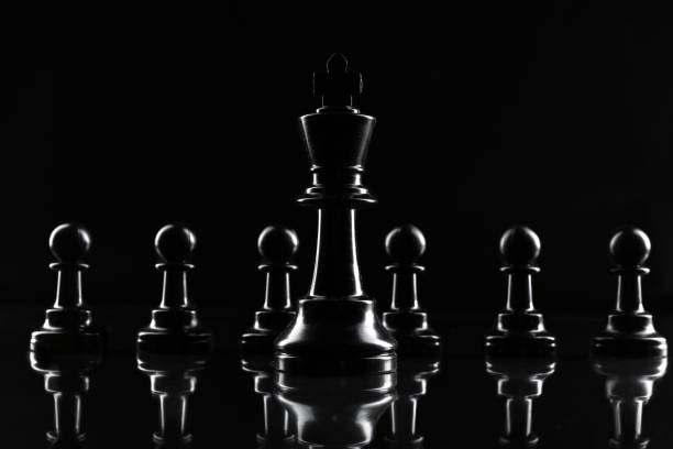istock Chess figures on dark black background close up 1432530646