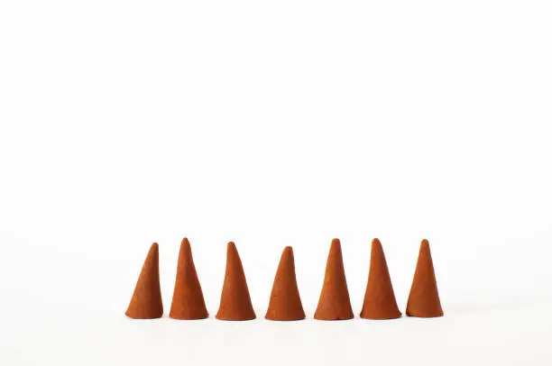 Brown color, aromatic cones isolated on white background with selective focus.