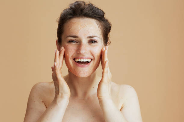 istock smiling modern 40 years old woman with face scrub 1432532156