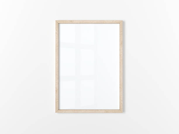 istock Blank frame. Poster mockup. Vertical wooden frame hanging on a white wall. Isolated. 1432532257