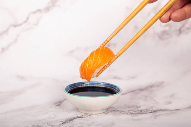 Salmon nigiri, chop sticks and soy sauce