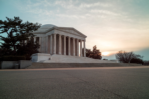 The Jefferson Memorial in Washington, D.C. on a winter evening at sunset. Low angle wide shot. No people.