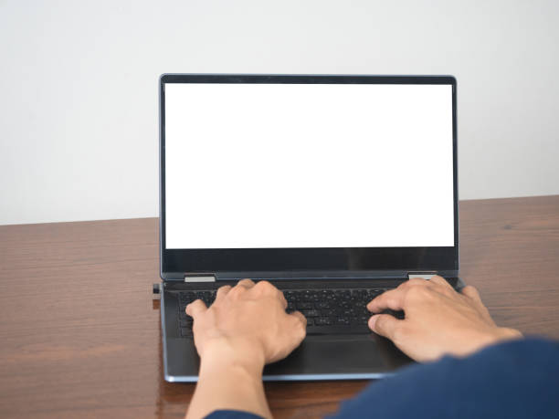 istock Man hands using keyboard of laptop mockup white screen on the table 1432535191