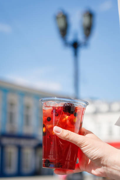 istock cold refreshing berry drink in a woman's hand 1432540598