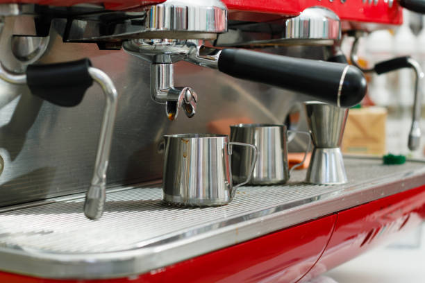 istock the red coffee machine is in operation. Dishes and accessories after making coffee. 1432540604