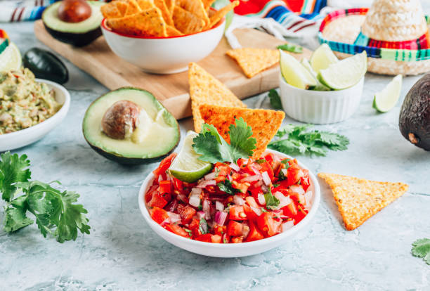 istock Salsa sauce and nacho chips on gray marble background. Mexican salsa sauce 1432542206