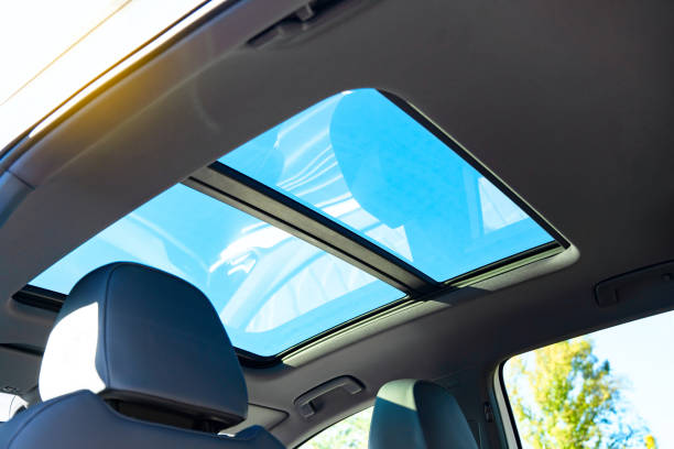 istock Automobile panoramic glass roof in a modern car. Blue sky view. 1432546493