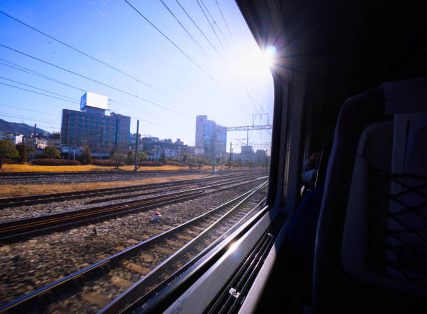 Traveler looking at the sunrise through the train window.