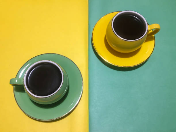 istock Coffee cups with saucers green and yellow 1432547280