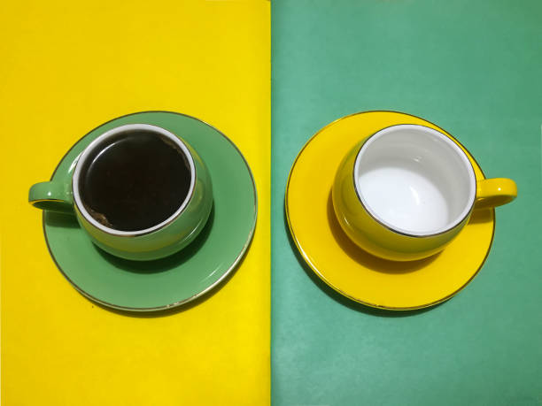 istock Coffee cups with saucers green and yellow 1432547283