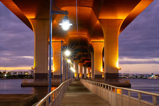 Sunset under the Roosevelt Bridge in Stuart, Florida with the street lights shining.