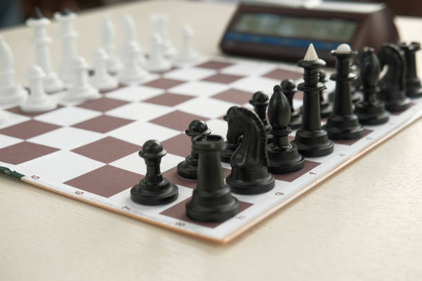 istock Chessboard and game figures. Blur and selective focus. Top view and shadows. 1432549339