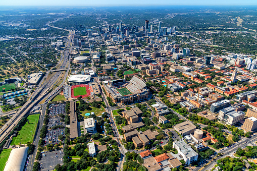 Austin, United States - September 29, 2022:  Wide angle aerial view of the city of Austin and surrounding areas shot from an altitude of about 2000 feet over the University of Texas at Austin campus; located in the foreground, with the skyline of downtown in the distance.