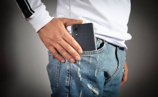 istock Man putting smartphone in pocket of jeans. 1432553939