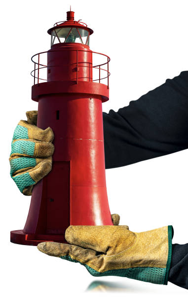 Gloved Hands Holding an Old Red Lighthouse Isolated on White Background