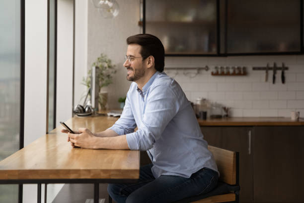 istock Happy young man pondering on phone message from beloved woman 1432556741