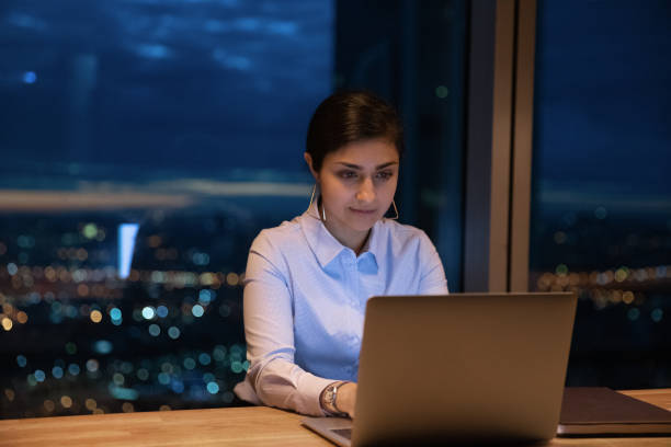 istock Young mixed race lady office employee type email on laptop 1432556825
