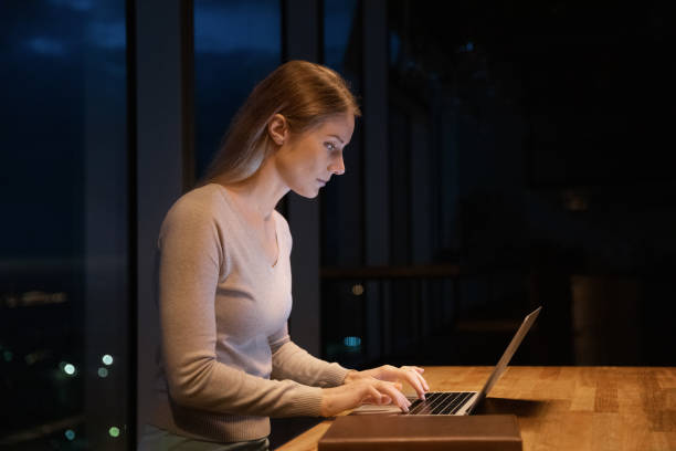 istock Young lady sit up late working on laptop in office 1432556838