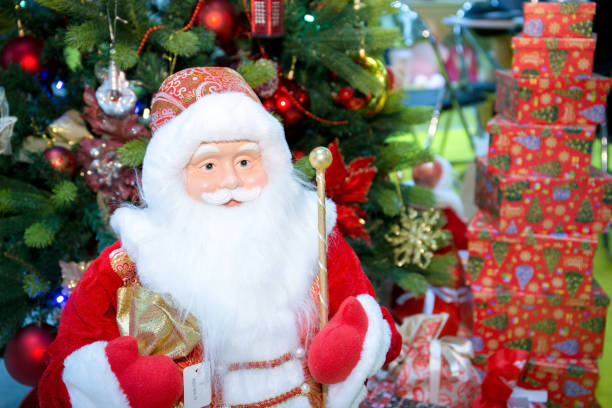 istock Santa Claus with a magic gift in his hands stands next to the Christmas tree. 1432557685