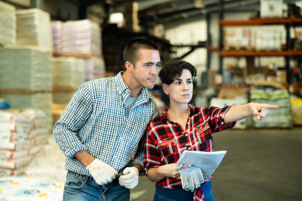 istock Woman and man dicsussing stock control in warehouse 1432559091