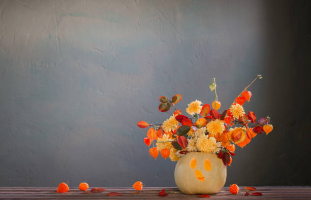 Halloween Jack O'Lantern in flower pot on front stoop