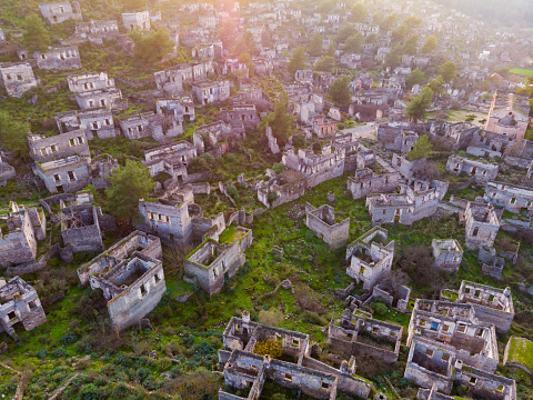 View from drone of ancient ruined settlement of Kayakoy with deserted houses and churches on mountain slope in Mugla Province, Turkey