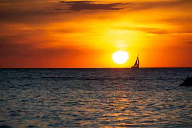 istock Sunset over the sea with a sailing ship on the horizon 1432559521