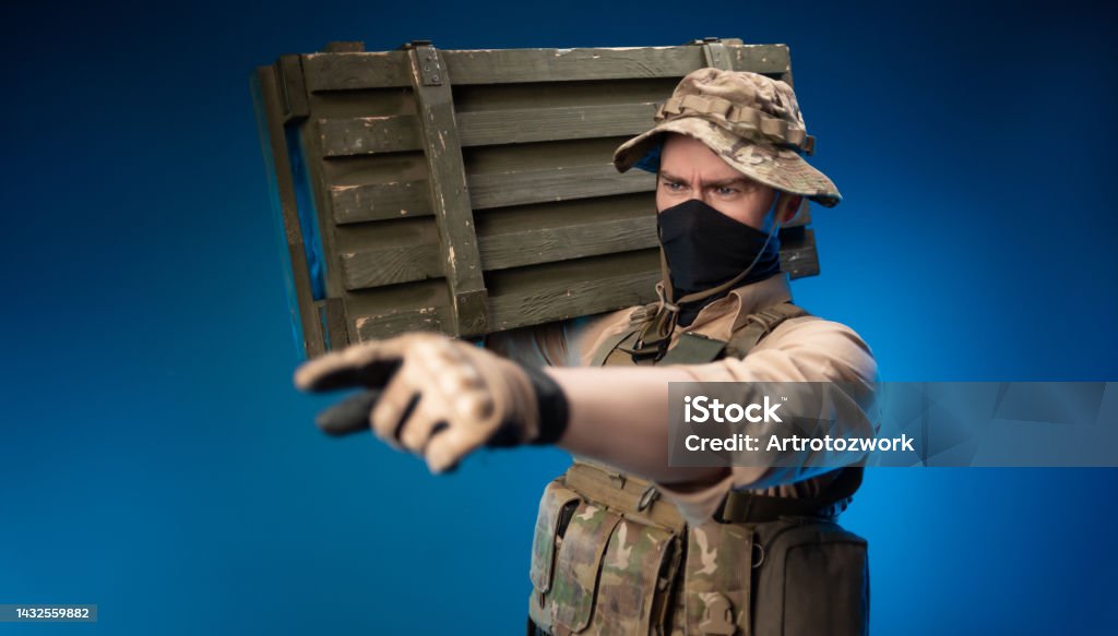 an army soldier in military clothes with a box of ammunition on his shoulder army soldier in military clothes with a box of ammunition on his shoulder 35-39 Years Stock Photo