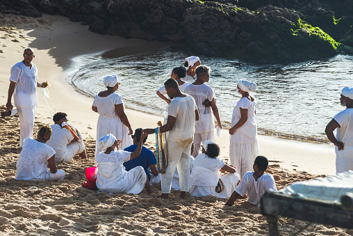 Salvador, Bahia, Brazil - December 12, 2021: Faithful of the Candomble religion are taking gifts to the queen of the sea. Rio Vermelho beach in the city of Salvador, Brazil.