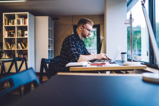 istock Male freelancer using laptop at desk 1432562813