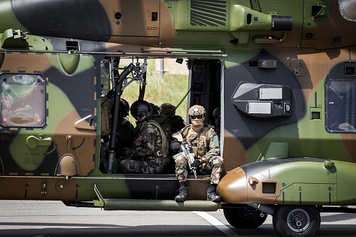 Military helicopter flying above a military base during a mission.