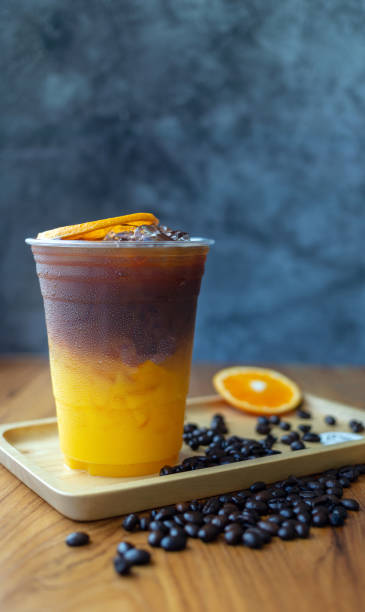istock iced coffee drink menu Orange Americano fusion with fresh orange fruit mixed in a plastic cup, drink menu product. 1432565761