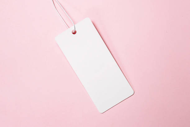 istock white tags, sale tag on pink background. Mockup, copy space for text, top view 1432566753