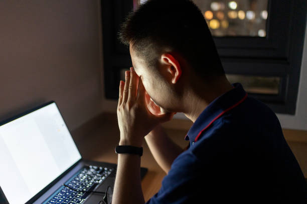 istock Asian man working at home late with laptop at night 1432566976