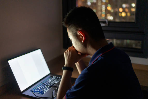 istock Asian man working at home with laptop at night 1432567393