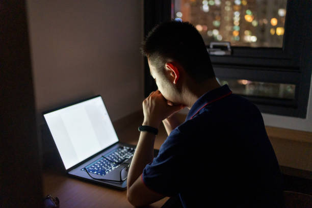 istock Asian man working at home with laptop at night 1432567395