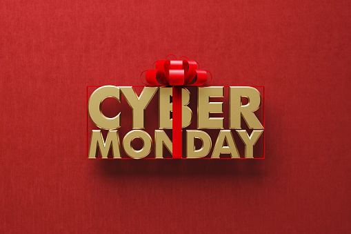 Gold colored Cyber Monday word wrapped by red ribbon on red background. Directly above. Horizontal composition with copy space. Great use for Cyber Monday concepts.