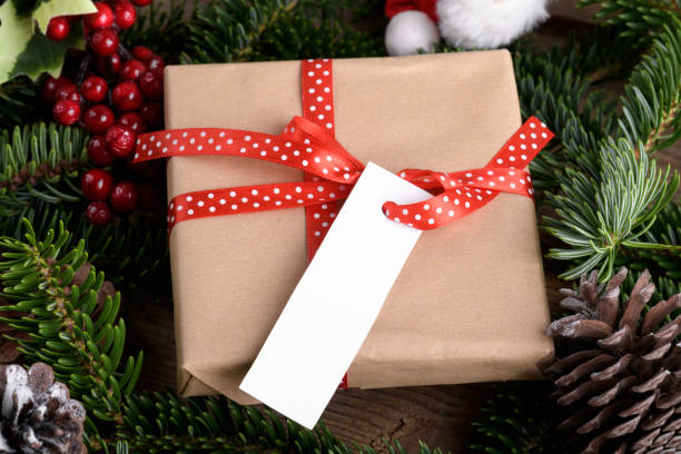 istock Christmas rectangle strip gift tag mockup with present box, product label mockup, with natural fir tree branch, name tag 1432568191