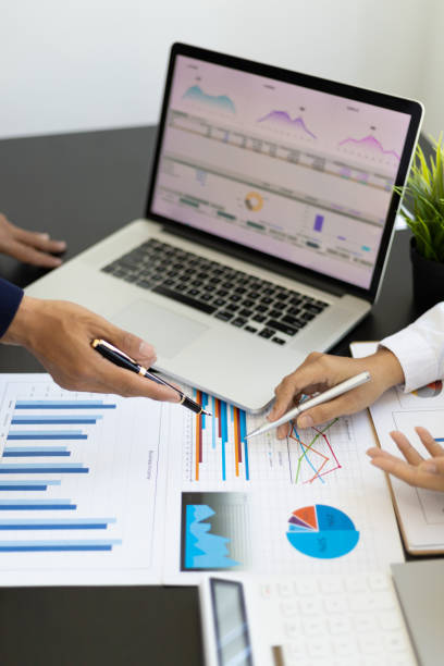 istock Accountants working on financial statement on laptop screen in office. Business consulting meeting working and brainstorming new business project finance investment concept. 1432568780