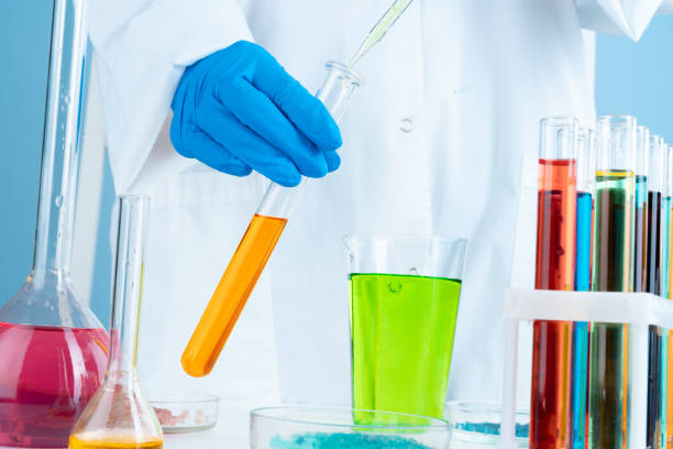 istock Manipulations with laboratory glass chemical containers on table 1432569197