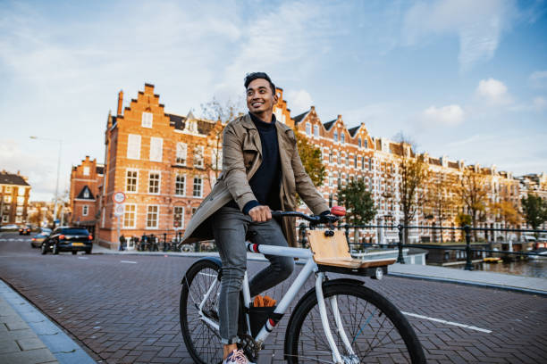 Millennial Asian tourist in the city with bicycle stock photo