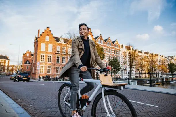 Photo of Millennial Asian tourist in the city with bicycle