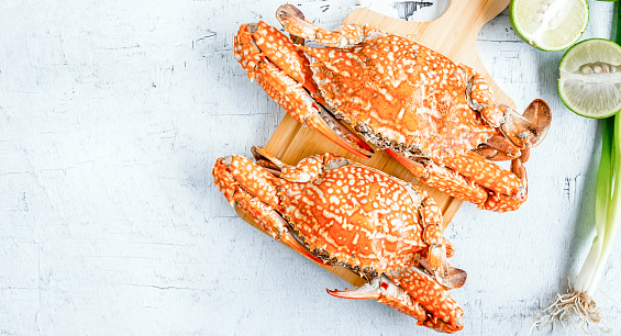 Top view of Cooked crab or blue crab menu Seafood steamed crab on a white wooden background