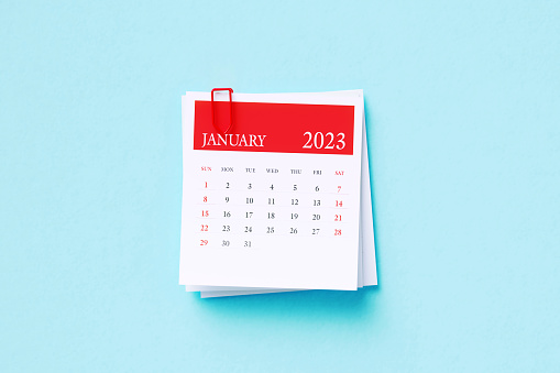 Post it January 2023 calendar on blue background. Directly above. Horizontal composition with copy space. Calendar and reminder concept.