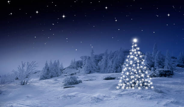 istock Shiny Christmas tree against a blue background in the snow 1432573833