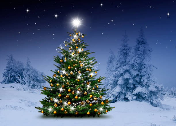 istock Shiny Christmas tree against a blue background in the snow 1432573880